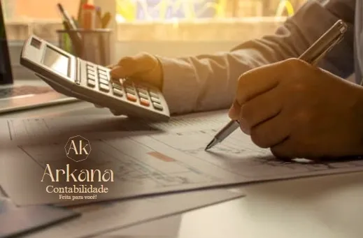 person-writing-to-paper-holding-a-calculator